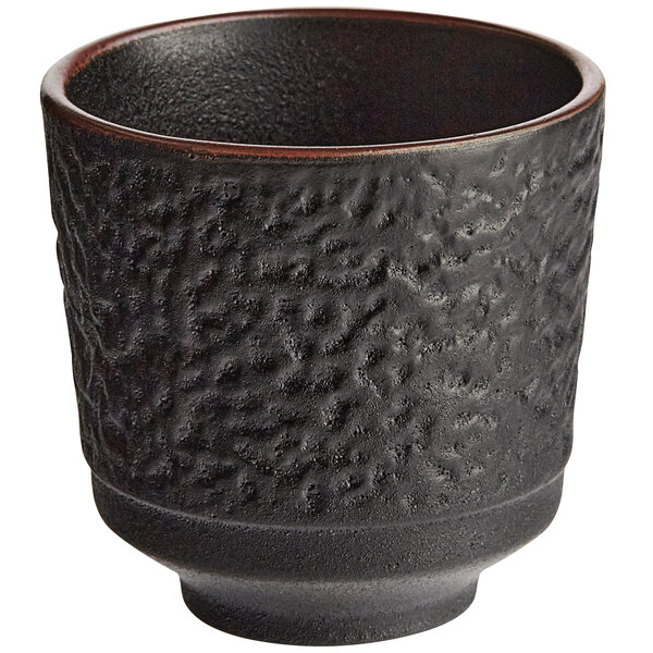 An Acopa Heika black textured stoneware tea cup.