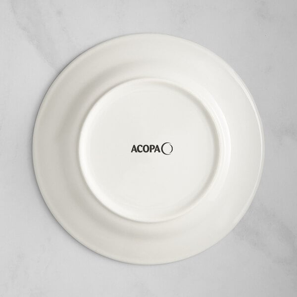 An Acopa ivory stoneware plate with blue bands and black text that says "Acopa" on the rim.