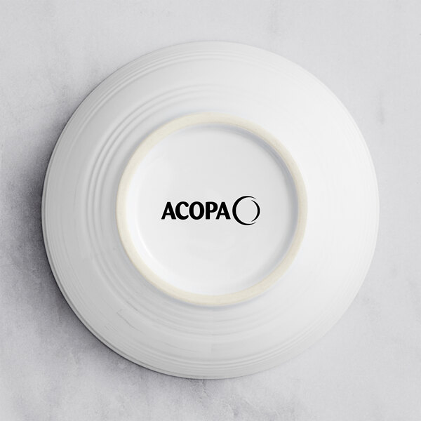 A white Acopa stoneware bowl with black text on it.