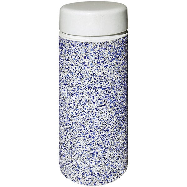A white concrete cylinder with a blue and white speckled surface.