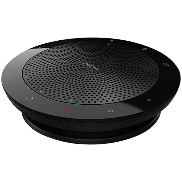 A black Jabra Speak 510 portable desktop speakerphone on a round black surface.