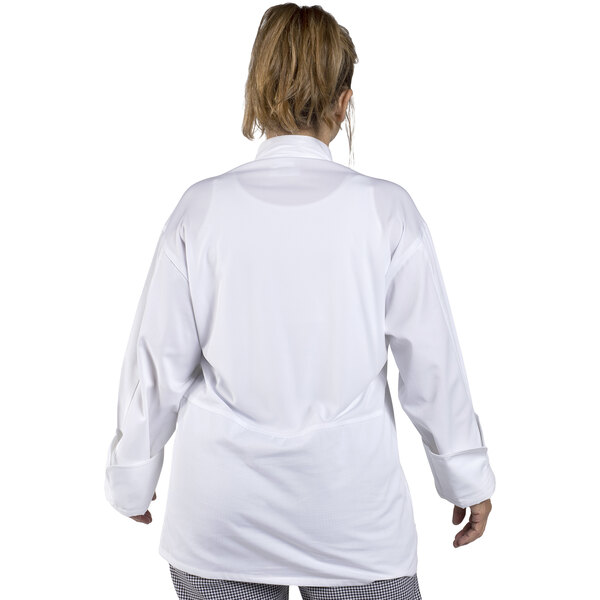 A woman wearing a Uncommon Chef white long sleeve chef coat with mesh back.