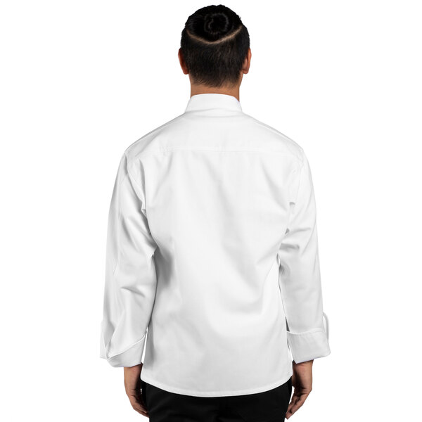 A man wearing a Uncommon Chef Sienna white long sleeve chef coat.