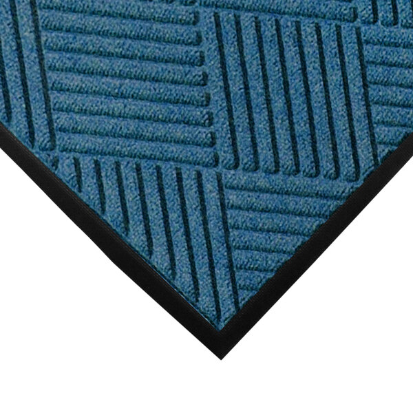 A close-up of a blue WaterHog entrance mat with black lines.