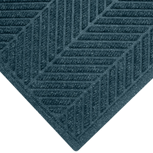 A close-up of a blue M+A Matting WaterHog Eco Elite Fashion mat with a chevron pattern.