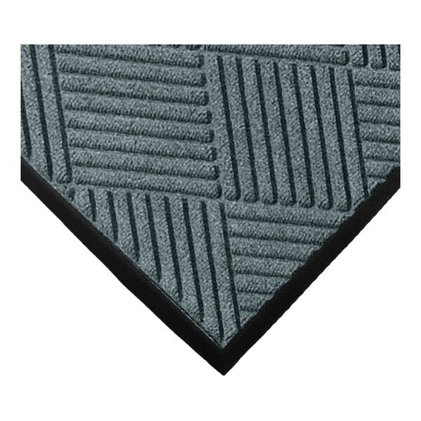 A close-up view of a textured mat with a geometric diamond pattern and a black border.