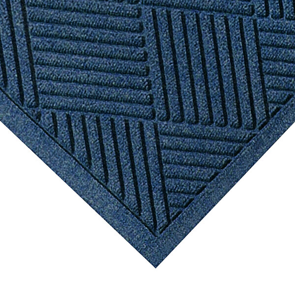 A close-up of a navy M+A Matting WaterHog carpet with a square pattern.