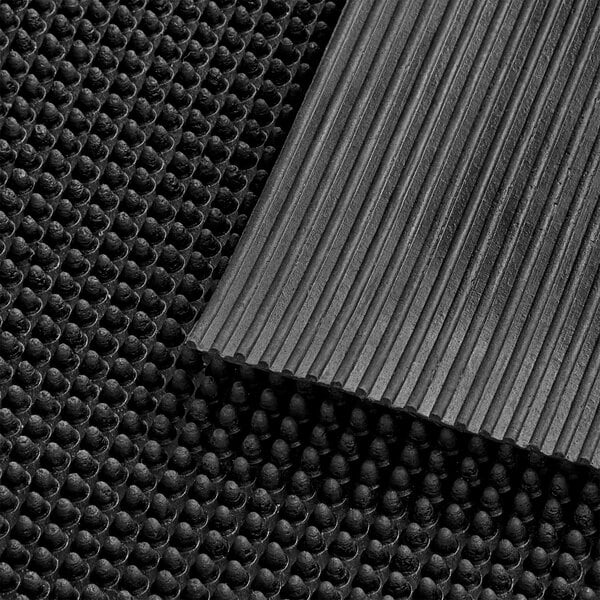 A close-up of a black Lavex anti-fatigue mat with a finger-scraper top.