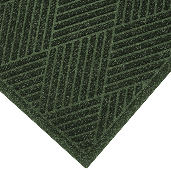 A green M+A Matting WaterHog Eco Premier mat with a square pattern and fabric border.