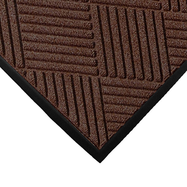 A close-up of a dark brown WaterHog mat with black stripes.