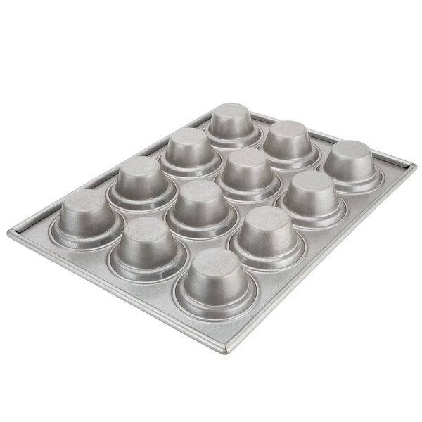 A close-up of a Chicago Metallic jumbo crown muffin pan with six muffins in it.
