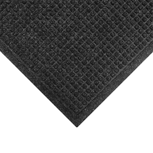 A close up of a black WaterHog mat with a square pattern and fashion fabric border.