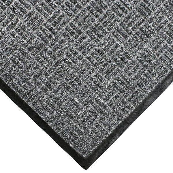 A grey WaterHog Masterpiece doormat with black border.