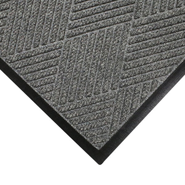 A close-up of a grey WaterHog carpet mat with black rubber border.