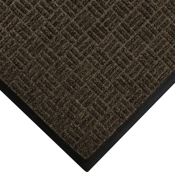 A brown WaterHog doormat with black trim.