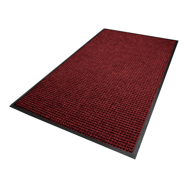 A rectangular mat with a textured red and black surface and a black rubber border.