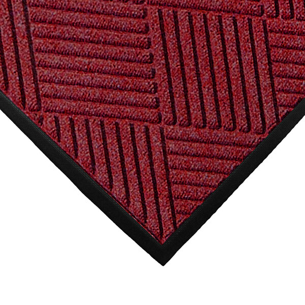 A red WaterHog mat with black diamond stripes on it.