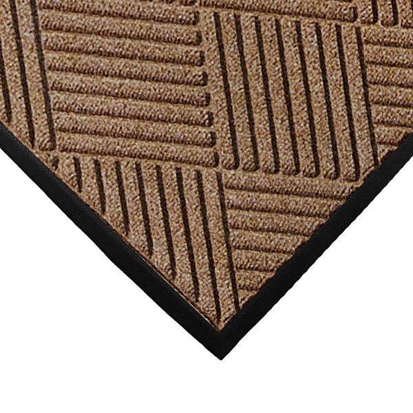 A close-up of a brown WaterHog mat with black stripes on it.