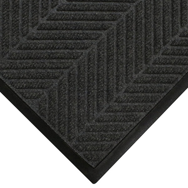 A close-up of a black WaterHog Eco Elite mat with a chevron pattern.