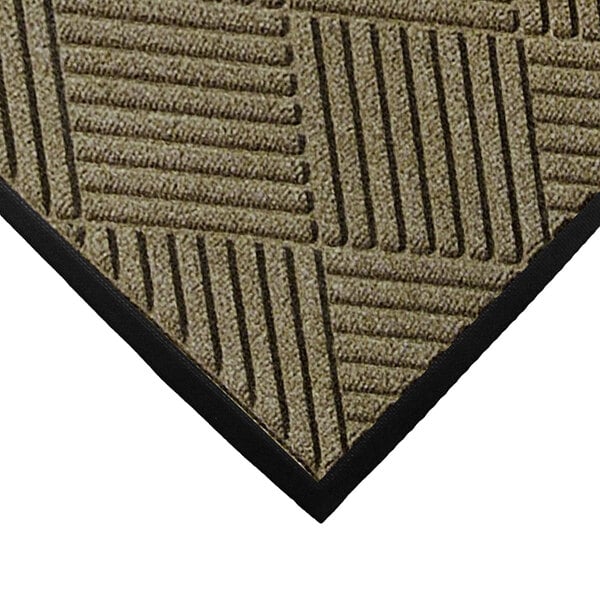 A close-up of a camel M+A Matting WaterHog Classic carpet mat with black stripes.