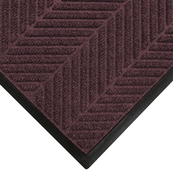 A maroon WaterHog floor mat with black trim.