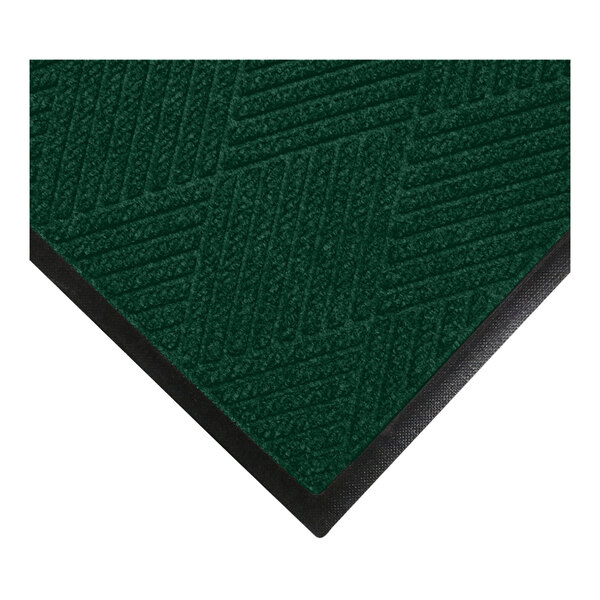 A close-up view of a green textured mat with a diagonal line pattern and a black rubber border.
