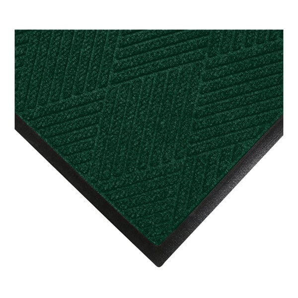 A close-up view of a green textured mat with a diagonal line pattern and a black rubber border.