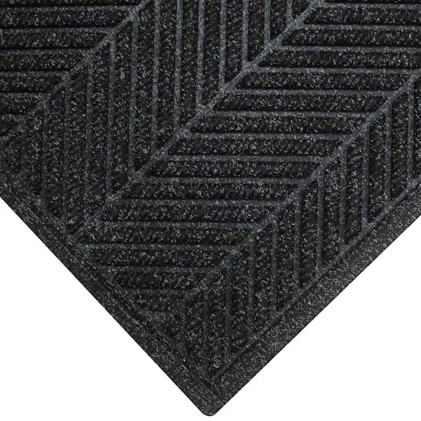 A black WaterHog doormat with a chevron patterned border.