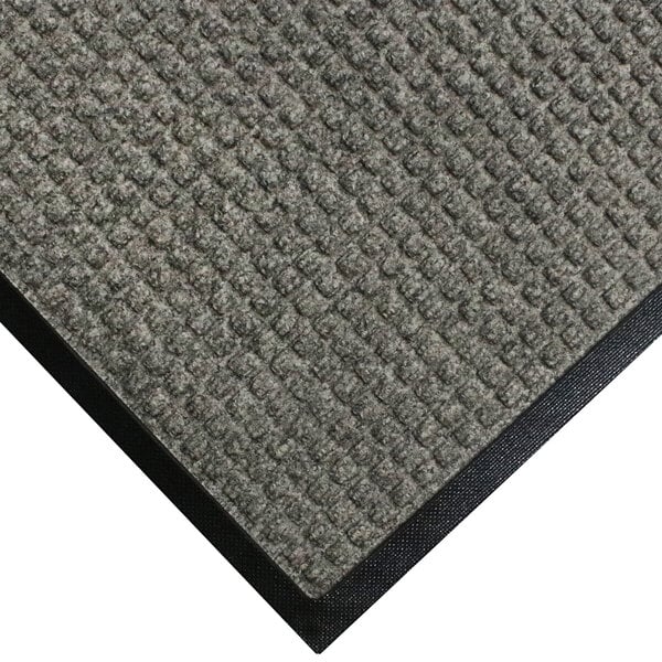 A close-up of a grey carpet mat with black border.