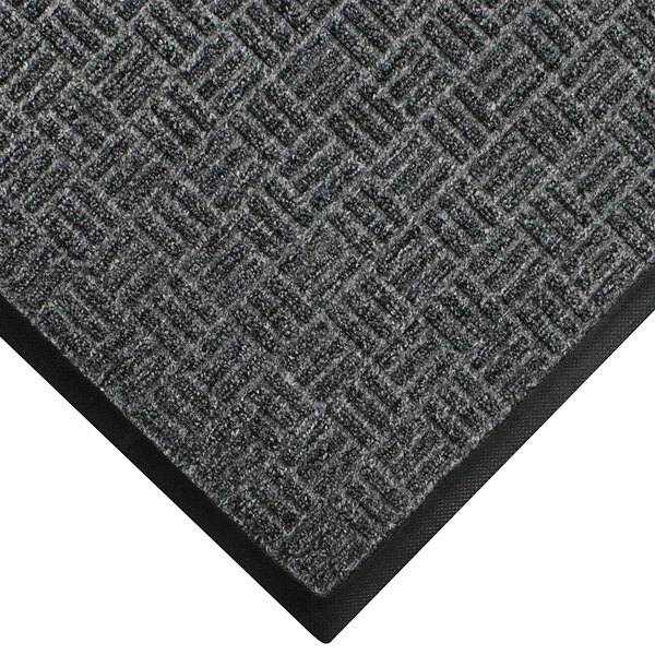 A close-up of a grey WaterHog Masterpiece carpet with black trim.