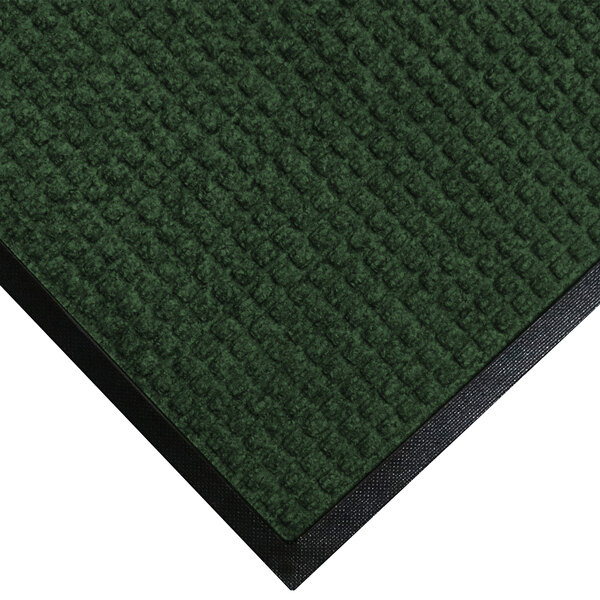 A green WaterHog Classic entrance mat with black rubber border.