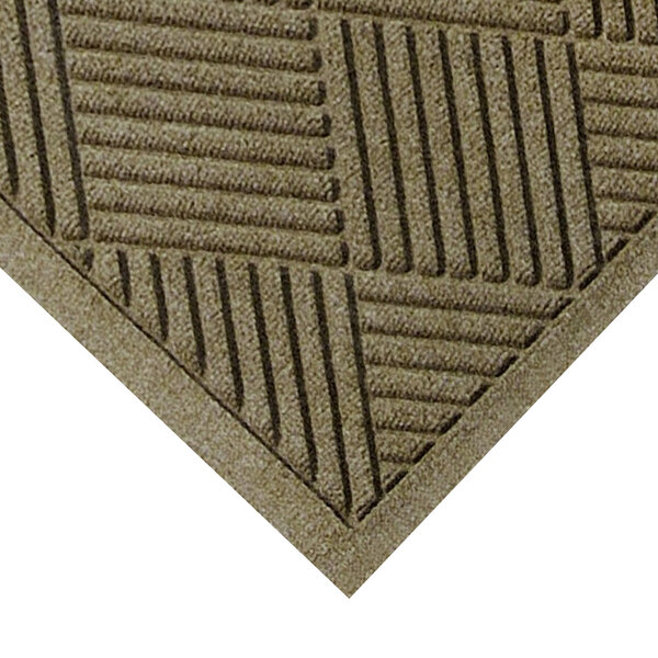 A close-up of a camel-colored WaterHog mat with a square pattern.