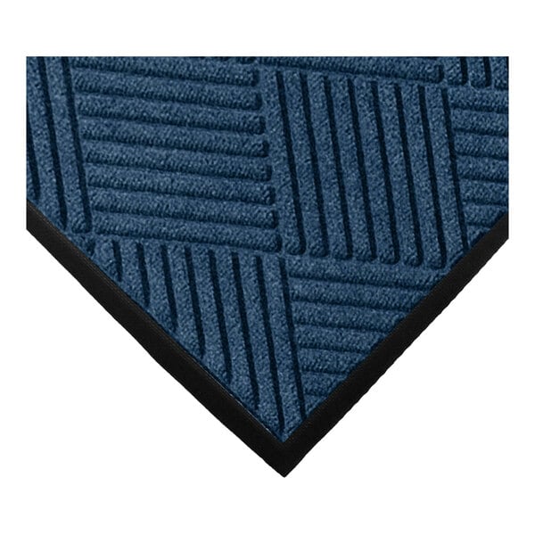 A close-up of a blue textured mat with a geometric diamond pattern and a black rubber border.