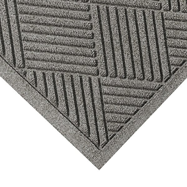 A close-up of a grey mat with a square pattern.