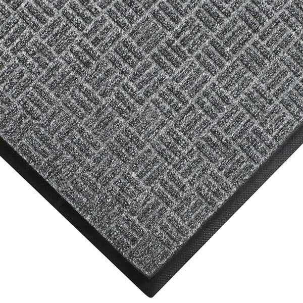A close-up of a grey WaterHog doormat with a black border.