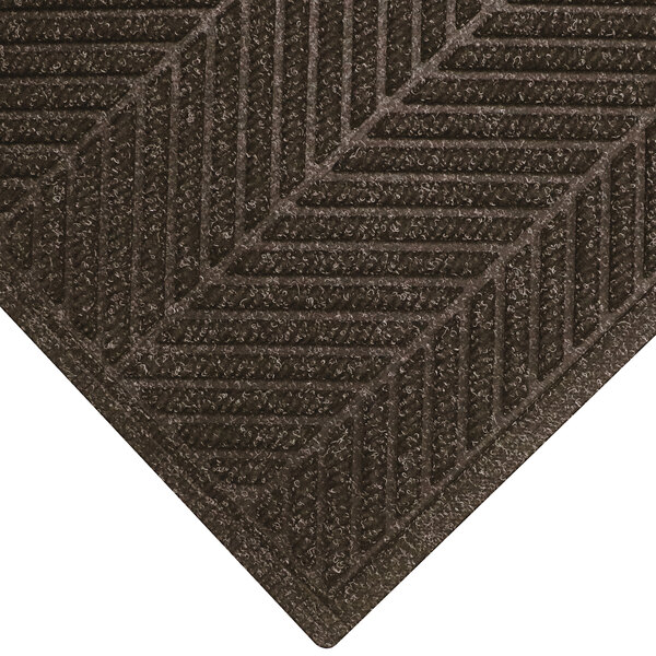 A brown M+A Matting WaterHog mat with a chevron pattern and a fashion border.