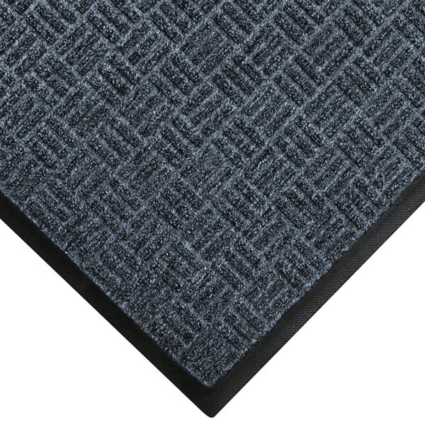 A black and gray carpet mat with a black border and an ocean wave pattern.