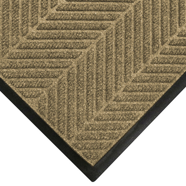A khaki M+A Matting WaterHog mat with a classic border.