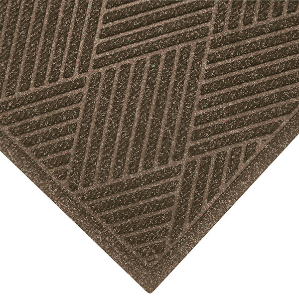 A khaki WaterHog entrance mat with a brown patterned border.