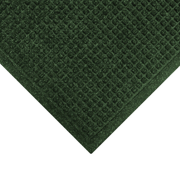 A green WaterHog entrance mat with a square pattern border.