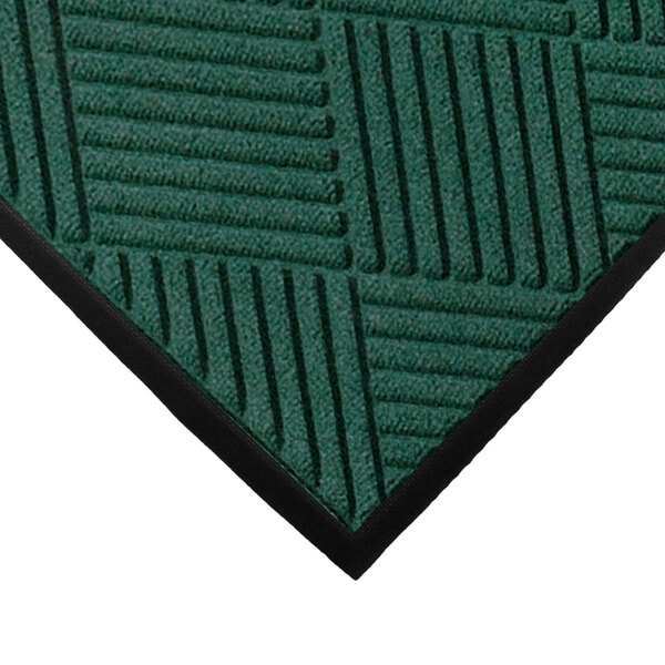 A green WaterHog mat with a diamond pattern and black rubber border.