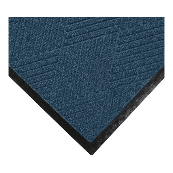 A close-up of a blue textured mat with a diagonal line pattern and a black rubber border.