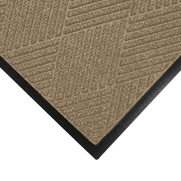 A khaki M+A Matting WaterHog mat with black rubber trim.