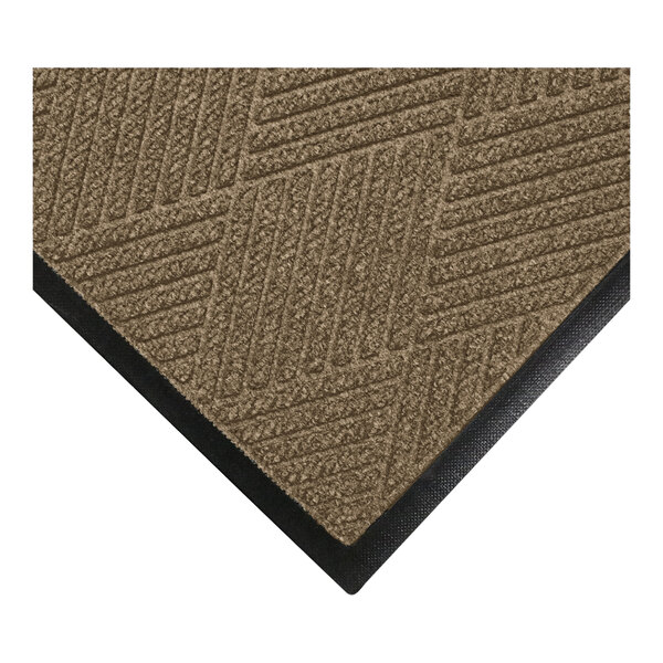 A close-up view of a brown textured mat with a geometric pattern and a black rubber border.