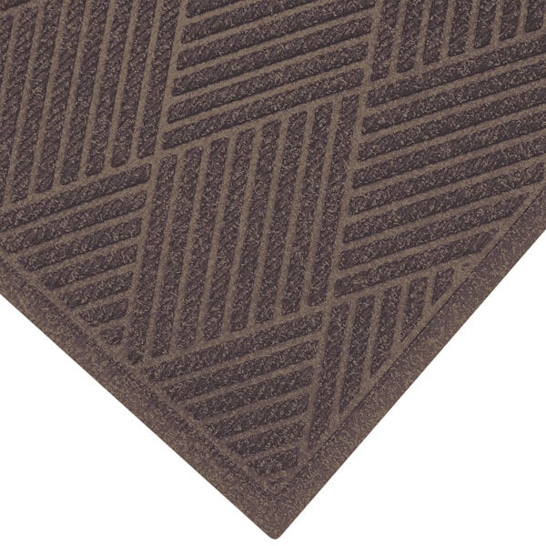 A brown WaterHog mat with a patterned fabric border.