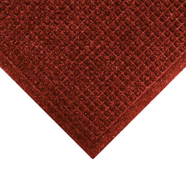 A red WaterHog carpet with a square pattern border.