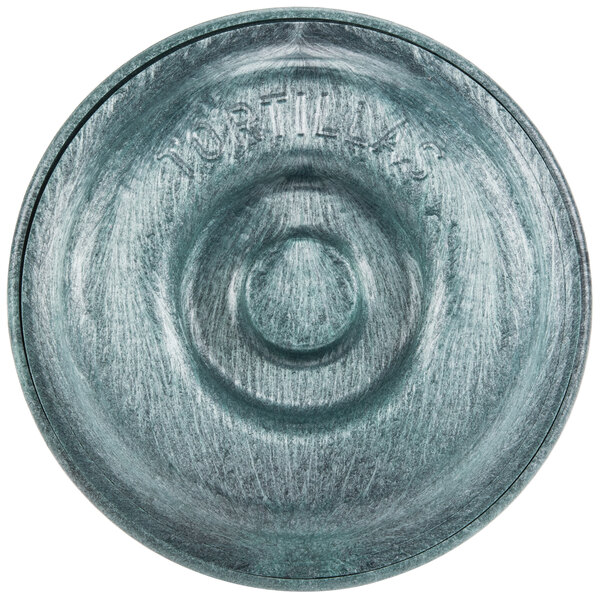 A green polyethylene circular tortilla server with a carved circular design.