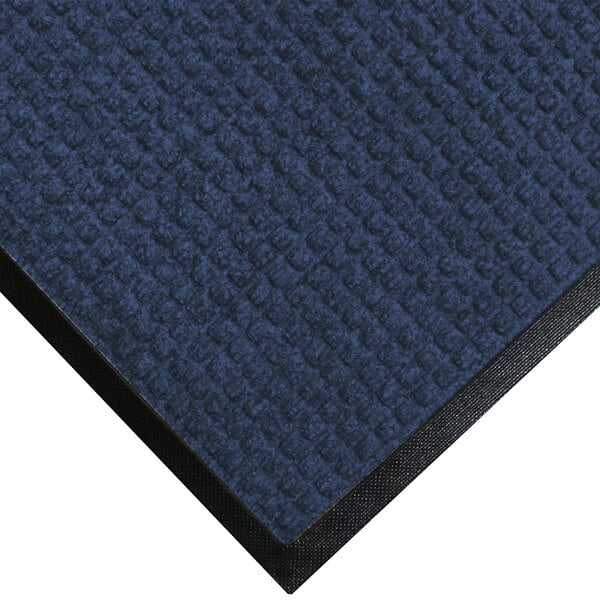 A blue WaterHog Classic mat with a black rubber border.