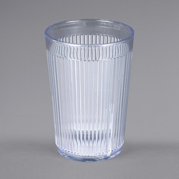 A clear plastic tumbler with a ribbed rim.