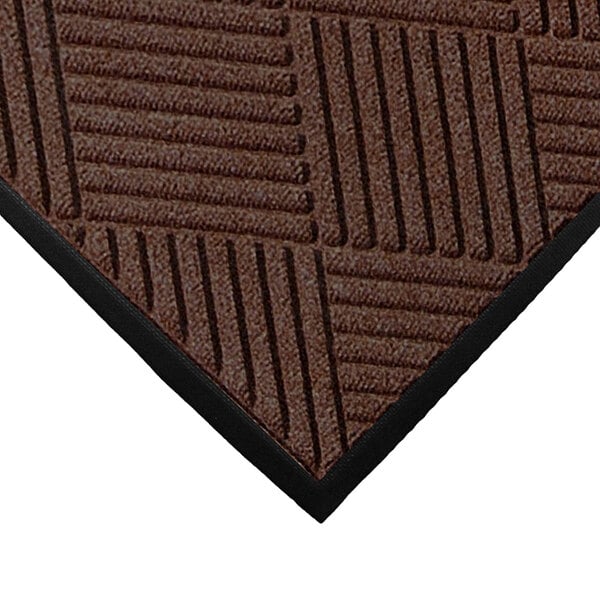 A close-up of a dark brown WaterHog entrance mat with black stripes on it.